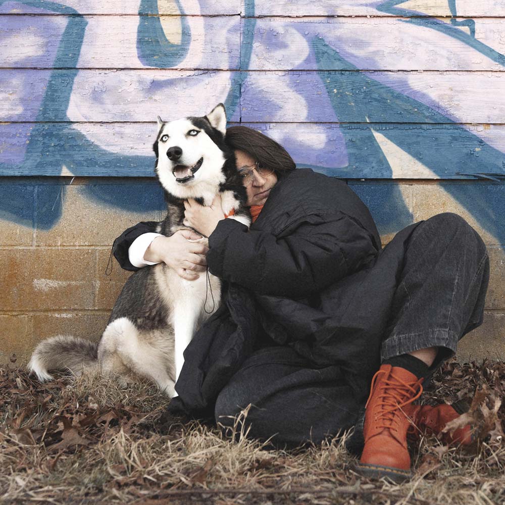 Sitting woman hugging a dog