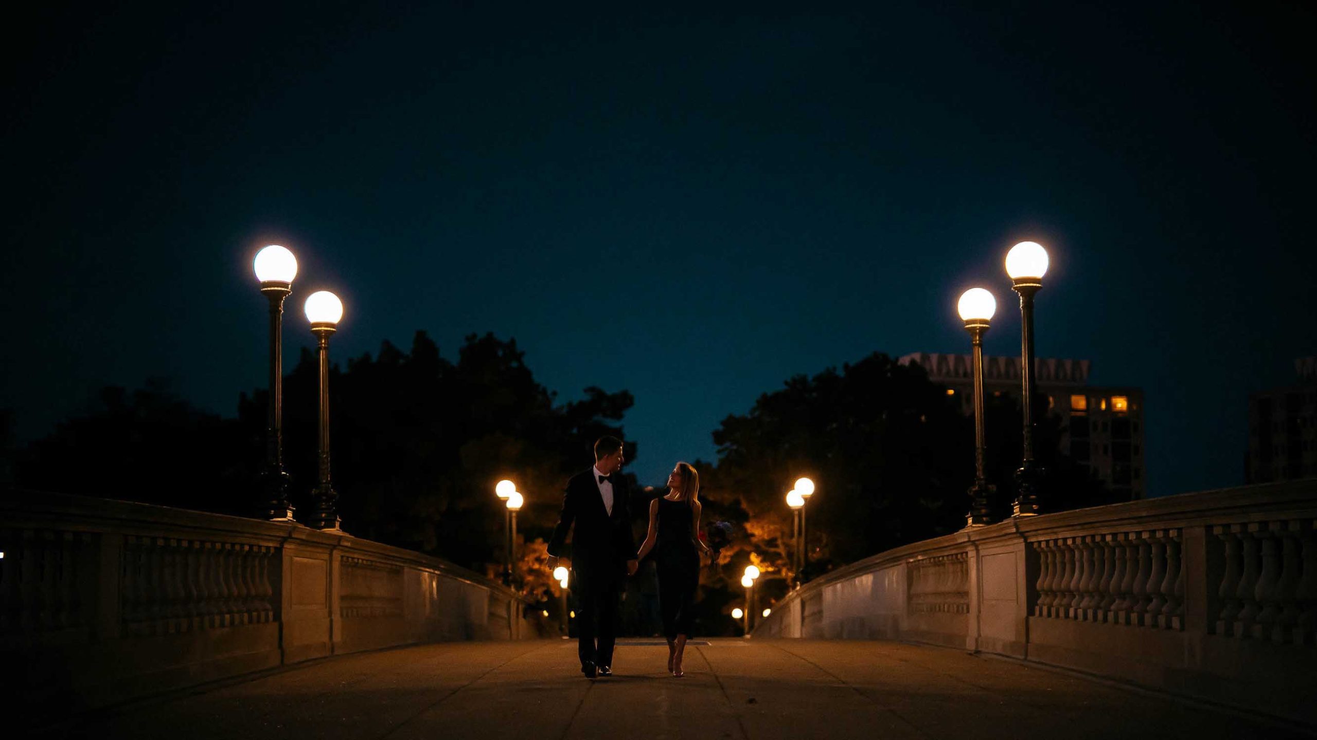 A couple on Weeks bridge in Cambridge at night