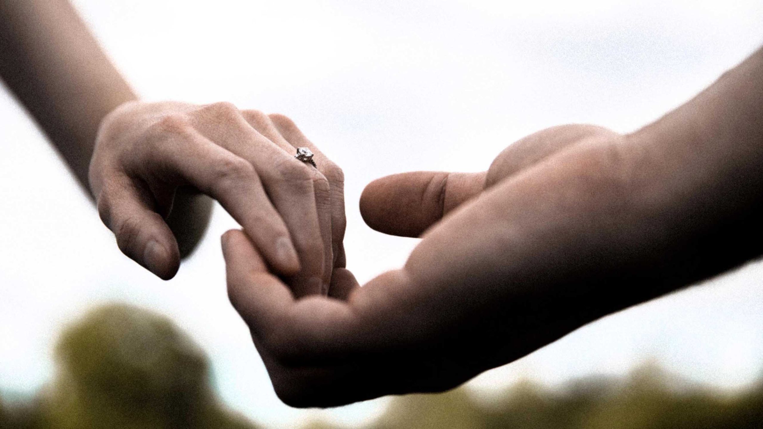 Hands on an engaged couple with an engagement ring