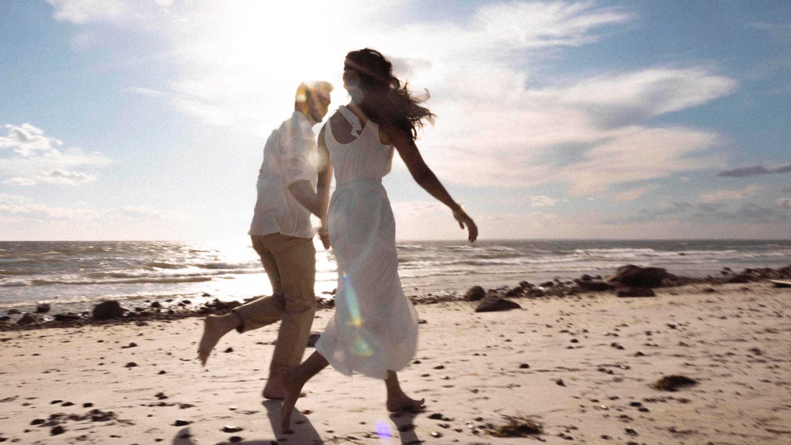 Lovers running on the beach