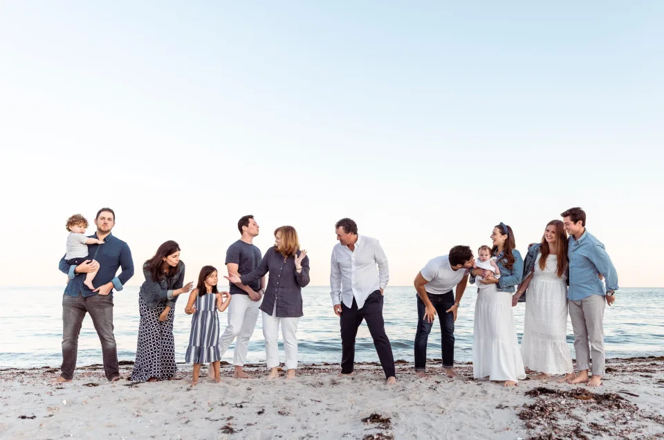 Family group posing for a photographer on the beach